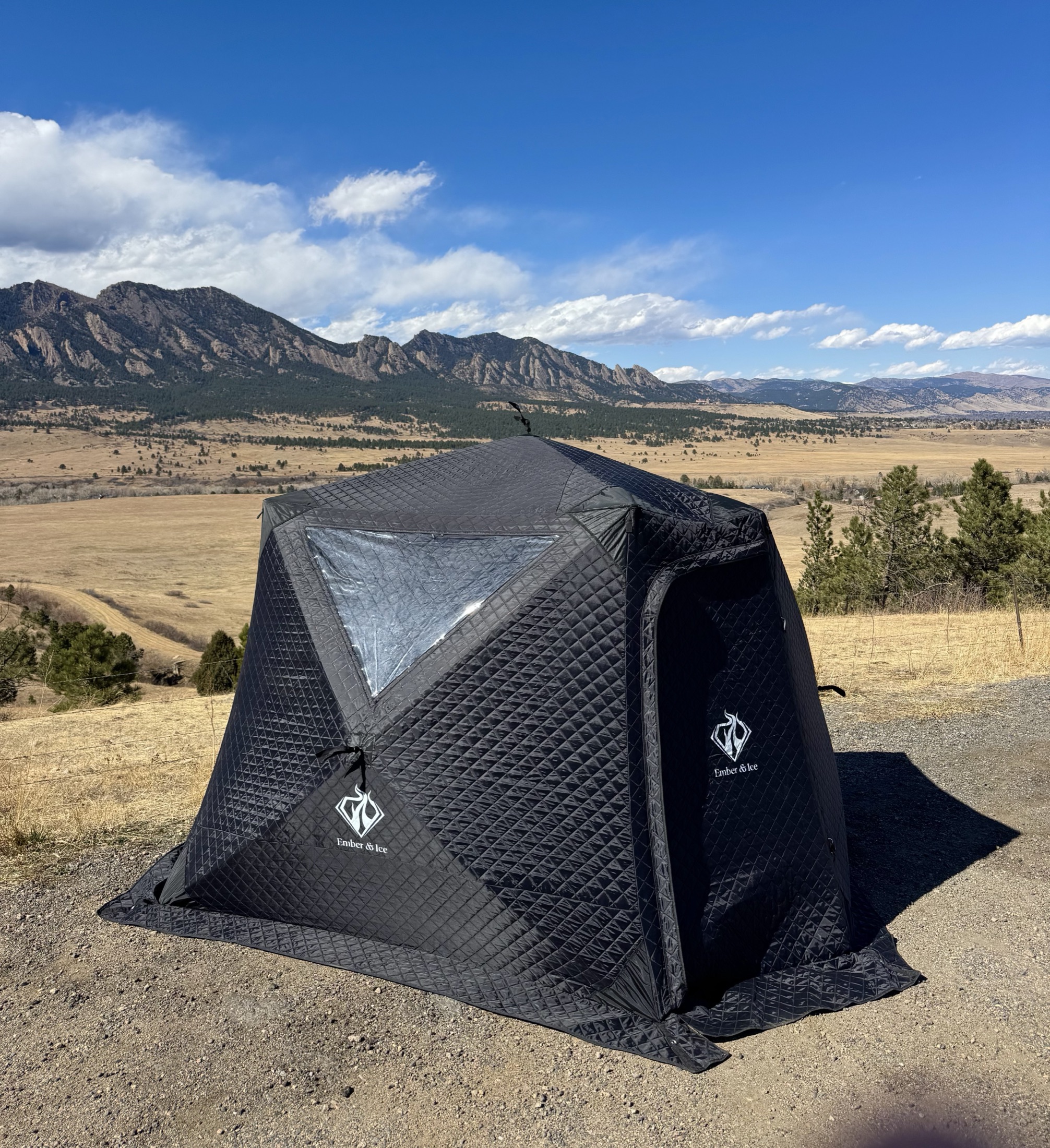 Ember & Ice sauna tent with the Boulder Flatirons behind it
